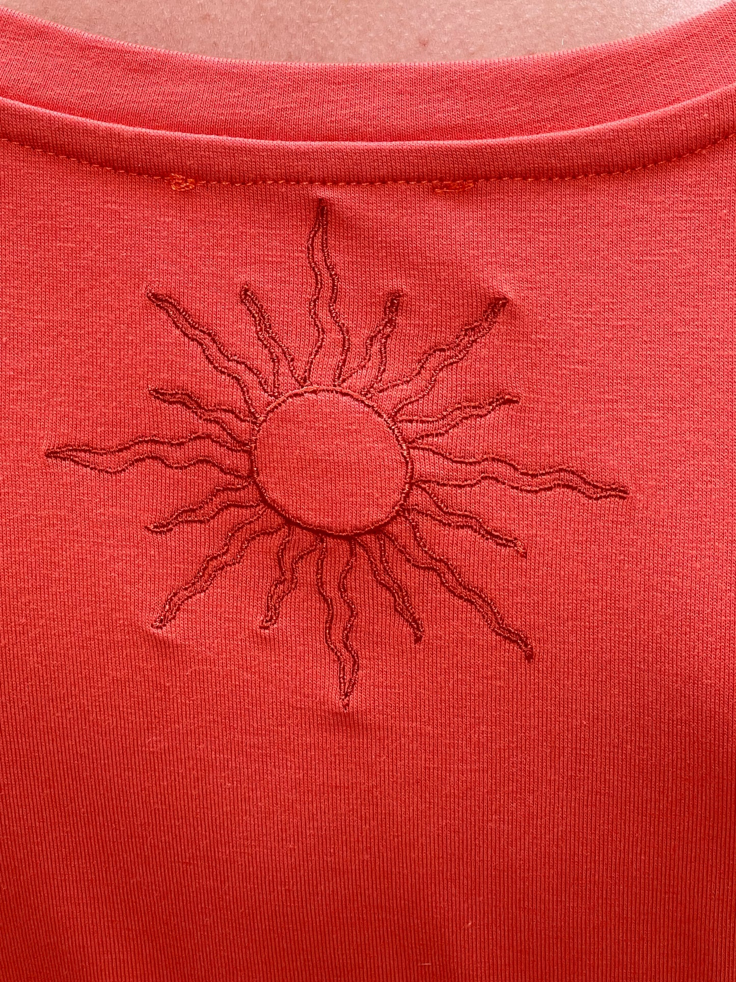 Maglia arancio yoga realizzata artigianalmente in Italia con ricamo sole